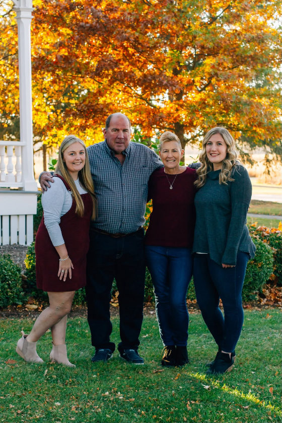 Bill Collins with his wife Karen and their daughters outside their Geneva home